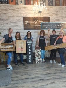 All About You Dental Care team members holding their wood projects.