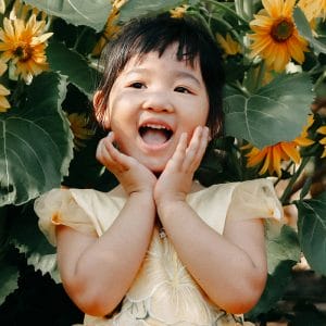 A young child smiling for her first dental visit.