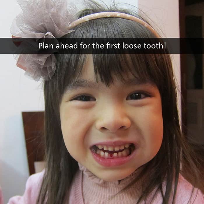 A smiling little girl who lost her first loose tooth