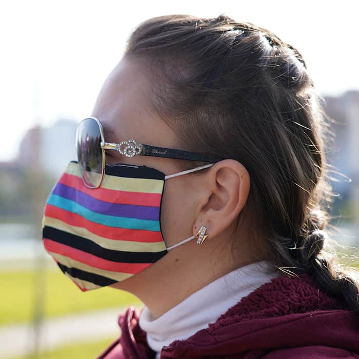 girl wearing a mask trying to avoid covid and covid fatigue