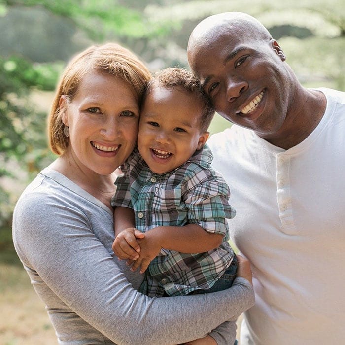 Happy family smiling because they found a new dentist