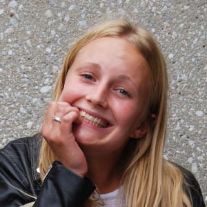 Young girl with a harmful habit that harms our teeth- nail biting