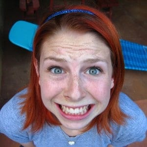 anxious girl with plaque on her teeth