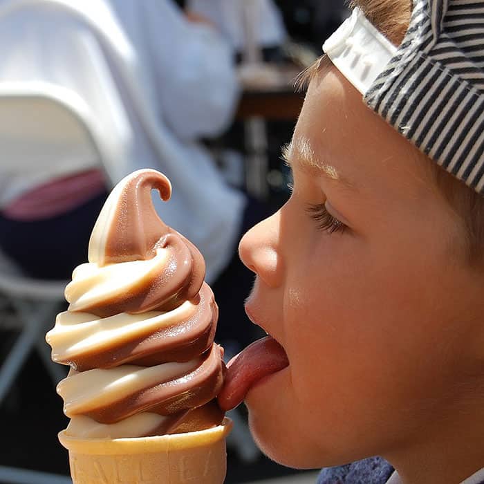 Young boy licking an ice cream cone