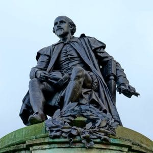 Statue of Shakespeare with his mouth closed to not show his rotten teeth